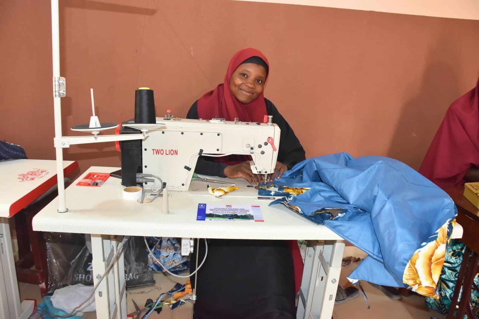 Young woman learning to sew at the Gidan Arziki business incubation unit