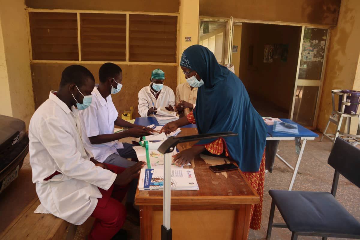 Health workers conducting screening during a community health outreach