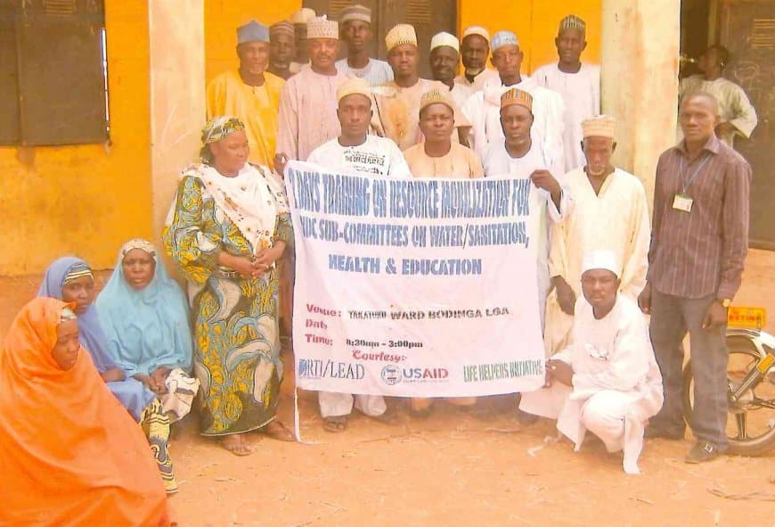 Community members holding a banner for the two-day resource mobilisation training for VDC sub-committees, Bodinga LGA