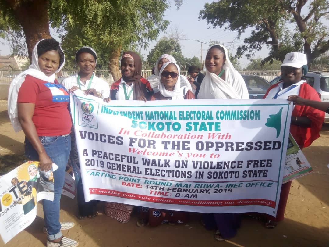 Women holding the INEC Sokoto “Voices for the Oppressed” banner for a peaceful walk on violence-free 2019 elections