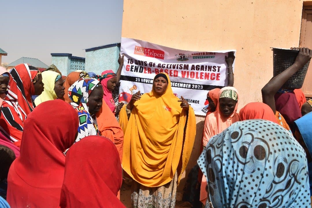 Women rallying beside a 16 Days of Activism against Gender-Based Violence 2023 banner