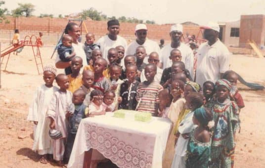 Children gathered round a table at an early LHI children's fun day