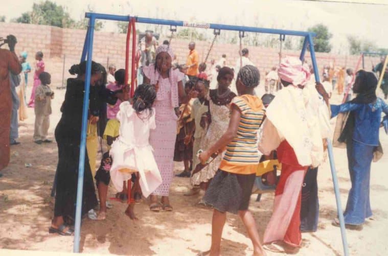 Children playing on swings at an early LHI children's event