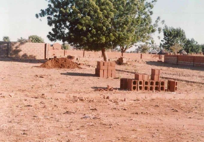 Sandcrete blocks stacked on the cleared site of the Goshen Development Centre