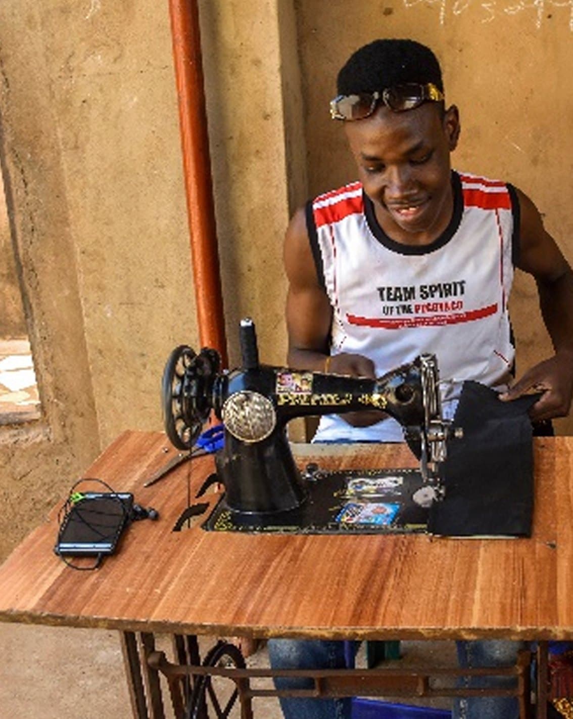 Mas'ud at his sewing machine after joining an IPT-G group in Bodinga, Sokoto