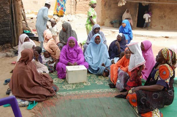 Women's group meeting in a village compound