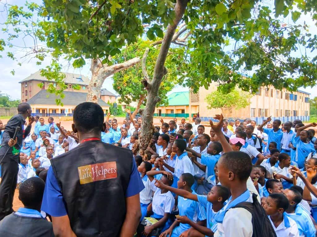 LHI staff member addressing a school assembly