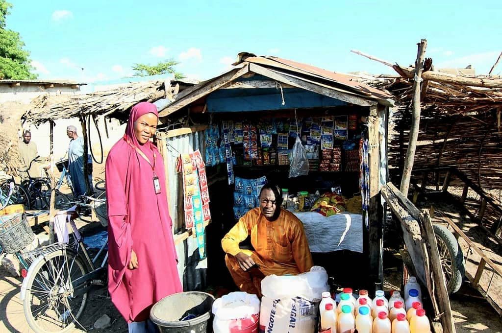 Woman entrepreneur standing proudly in front of her provisions shop