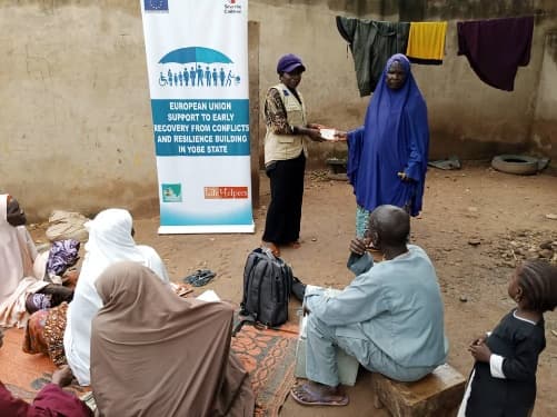 Women's savings group meeting under an EU early recovery project banner in Yobe State